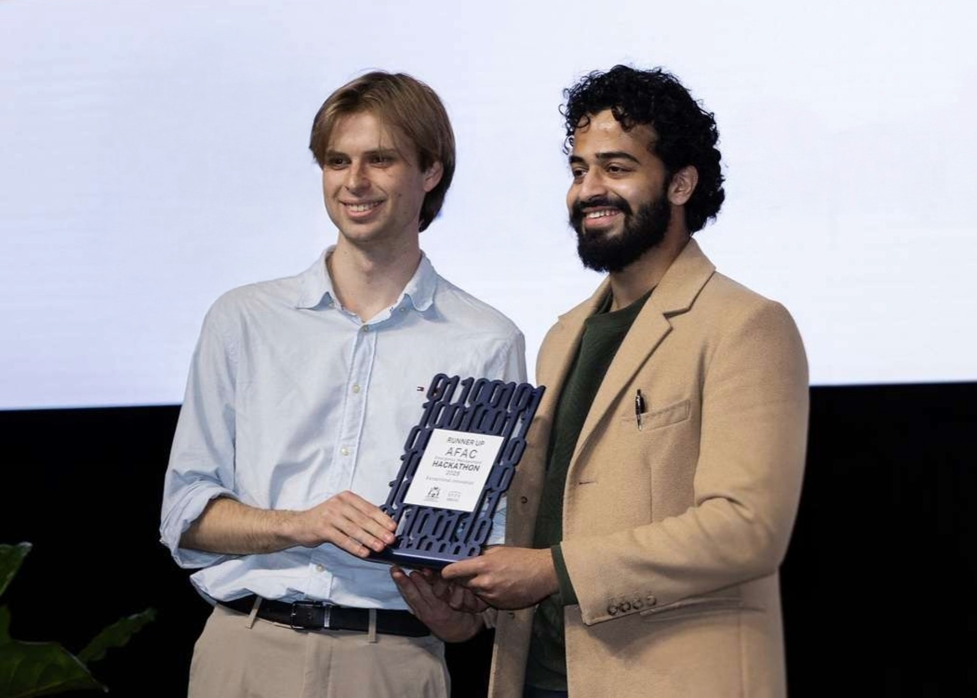 Ash and Michael accepting a runner-up trophy at the AFAC Hackathon